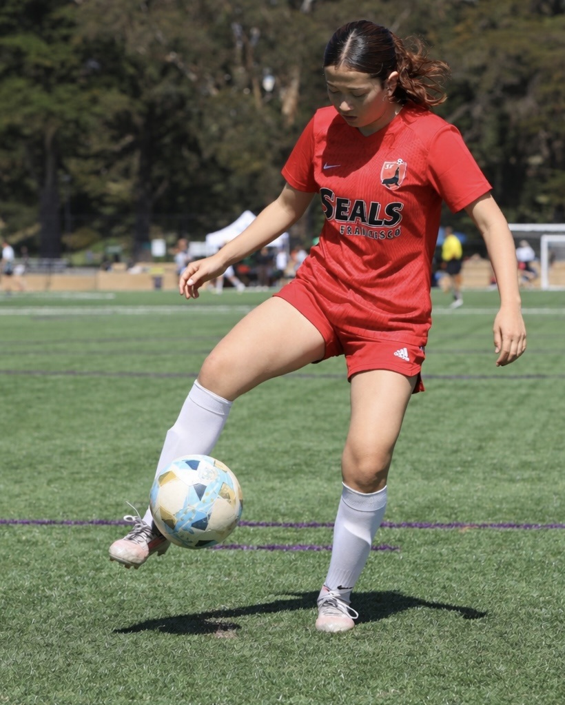 Ana controlling the ball during a soccer game