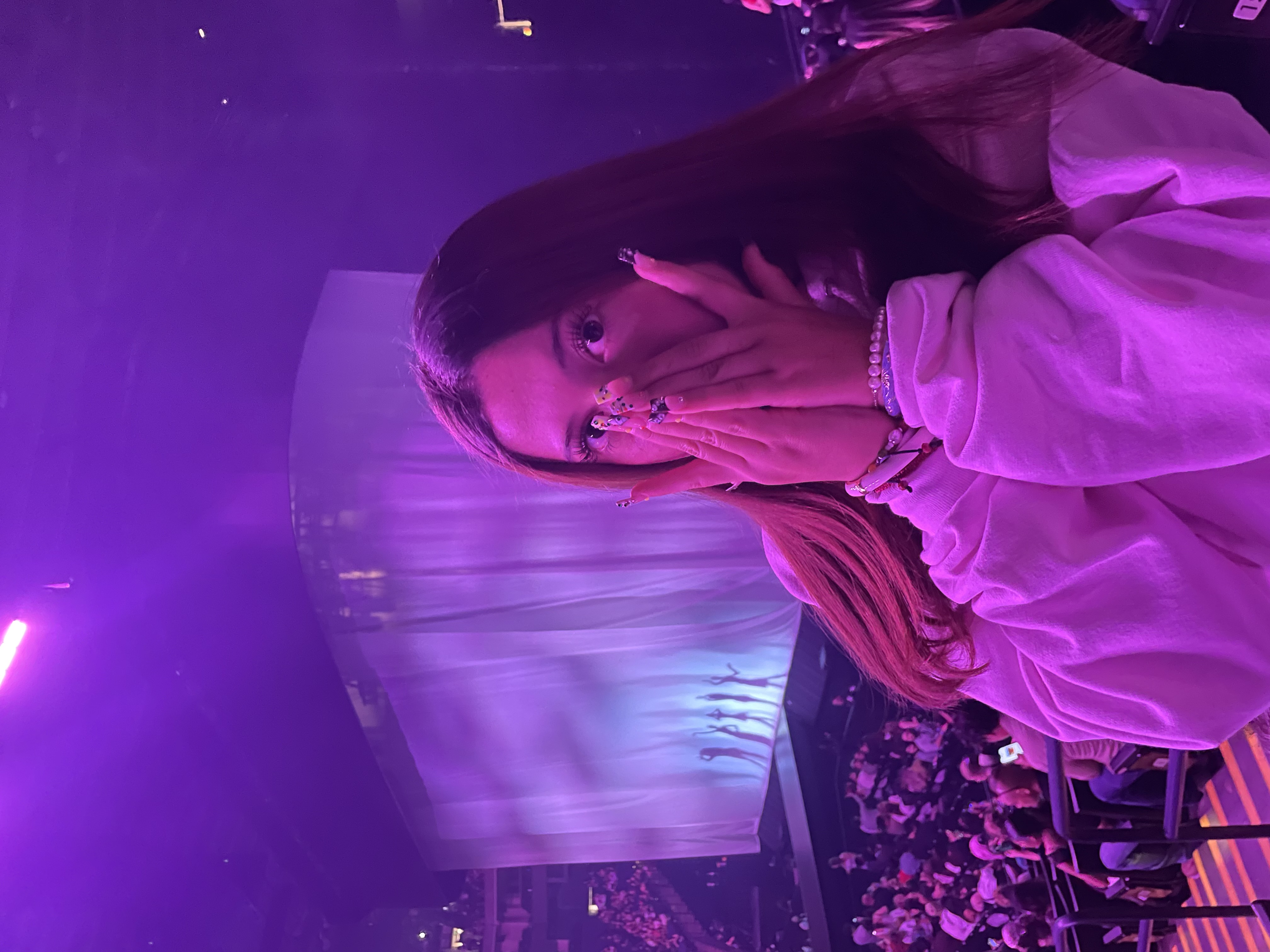 Ana enjoying a concert under purple lights